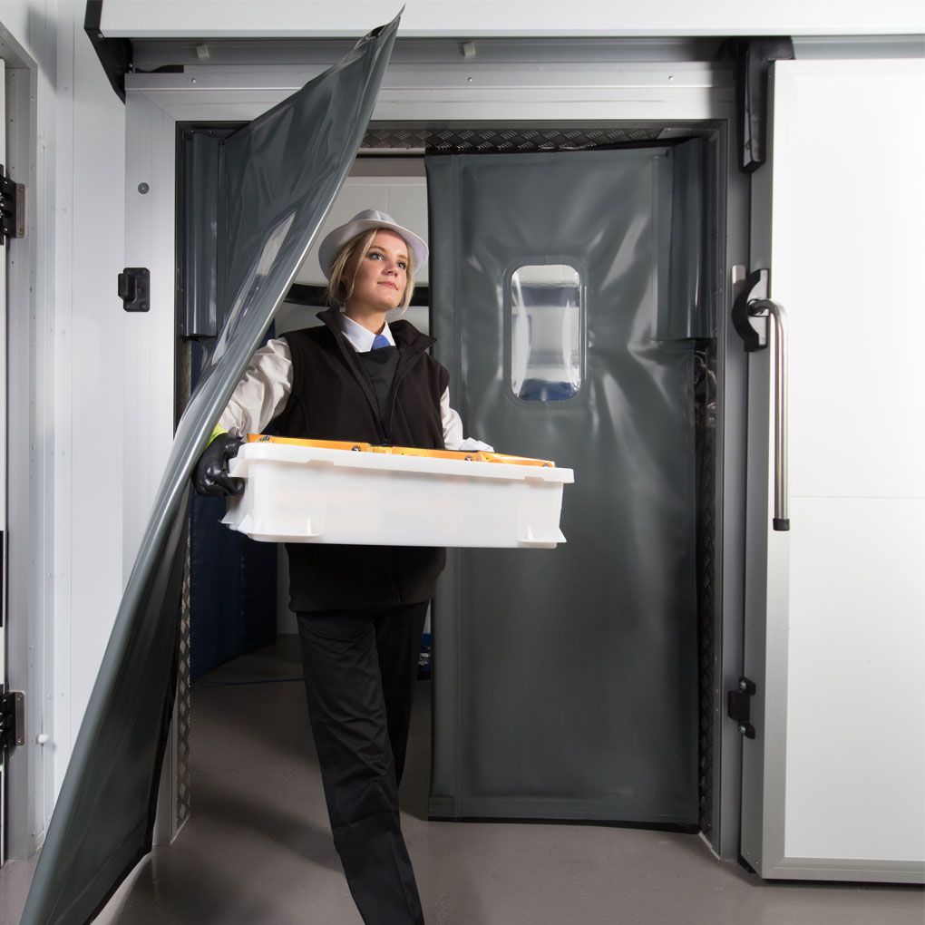 Staff member carrying a tray through a Kenfield K750 energy door